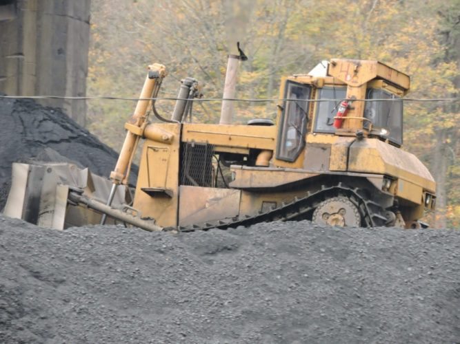 ON THE JOB -- A coal miner operates a bulldozer at Murray Energy Corp.'s Powhatan No. 6 Mine. -- Casey Junkins
